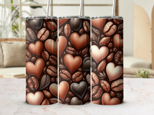 Three tumblers with coffee beans and heart designs.