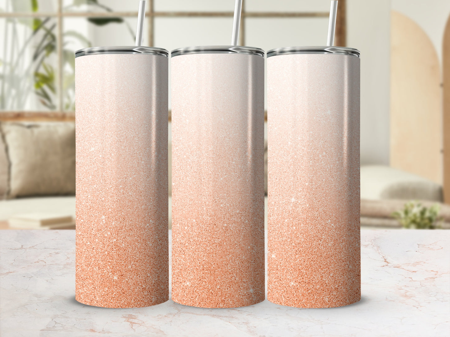Three tall tumblers with orange glitter gradient, set on a marble surface.