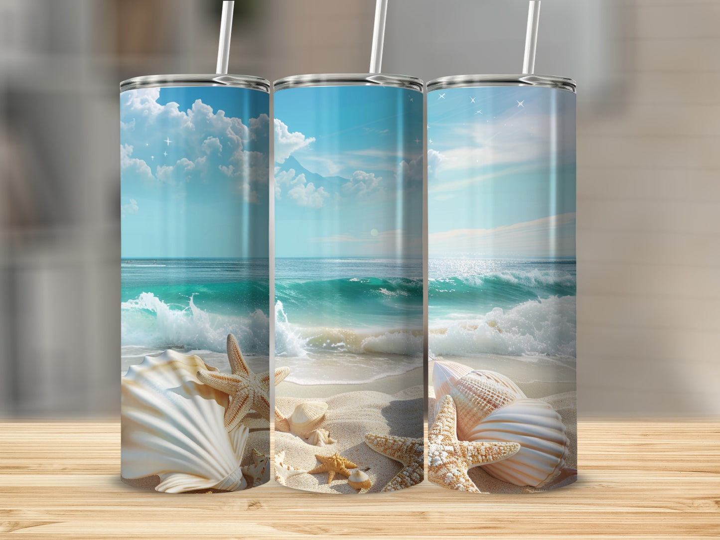 Three tumblers decorated with beach scenes, seashells, and ocean waves.