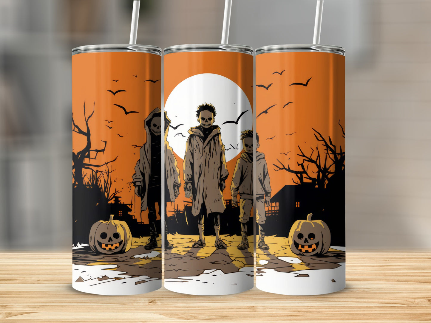 Three Halloween-themed tumblers with spooky figures, pumpkins, and bats.