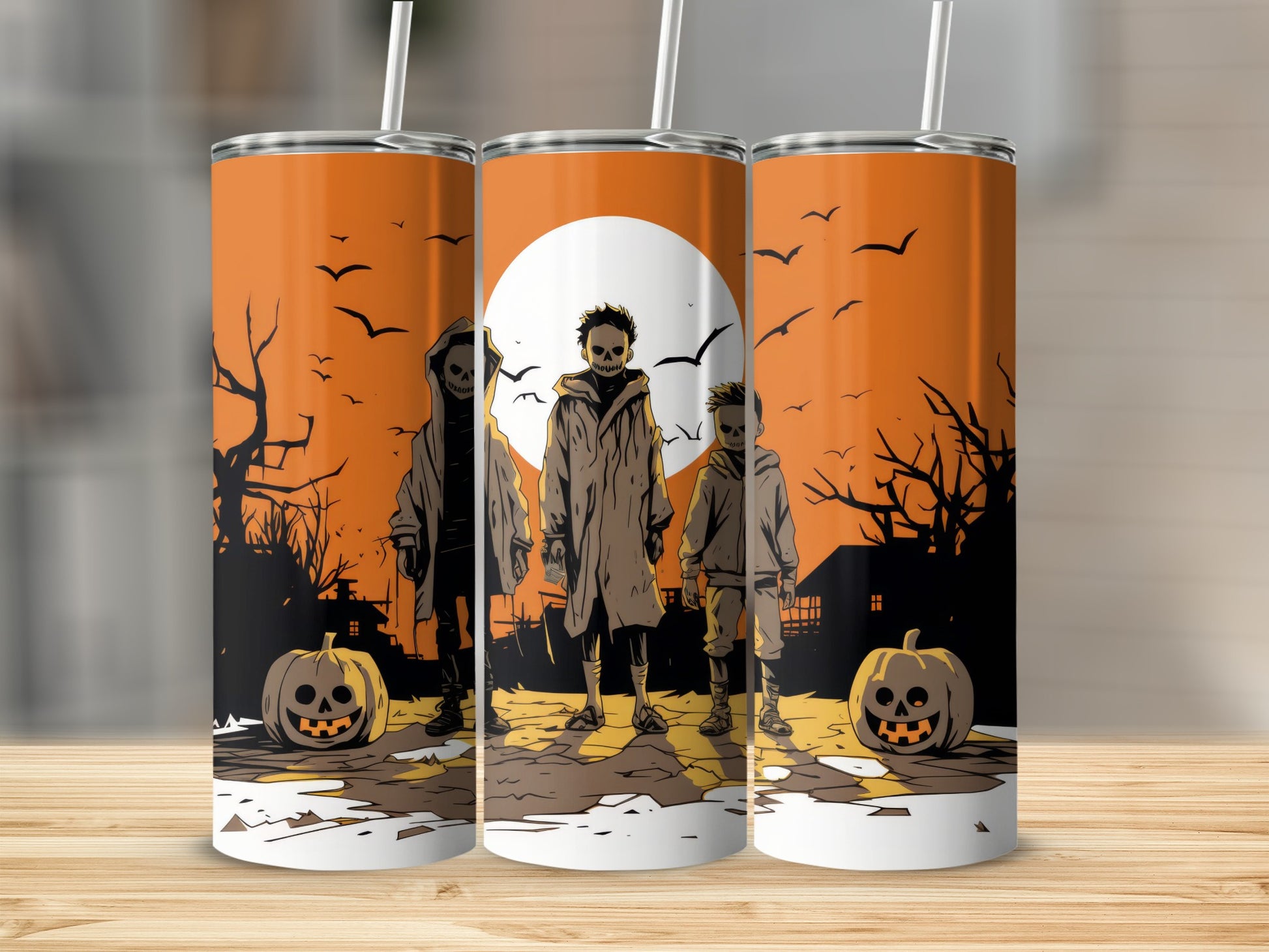 Three Halloween-themed tumblers with spooky figures, pumpkins, and bats.