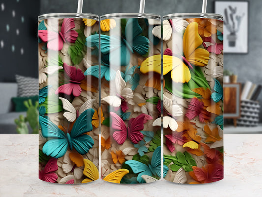 Three tumblers with colorful butterflies and floral designs.