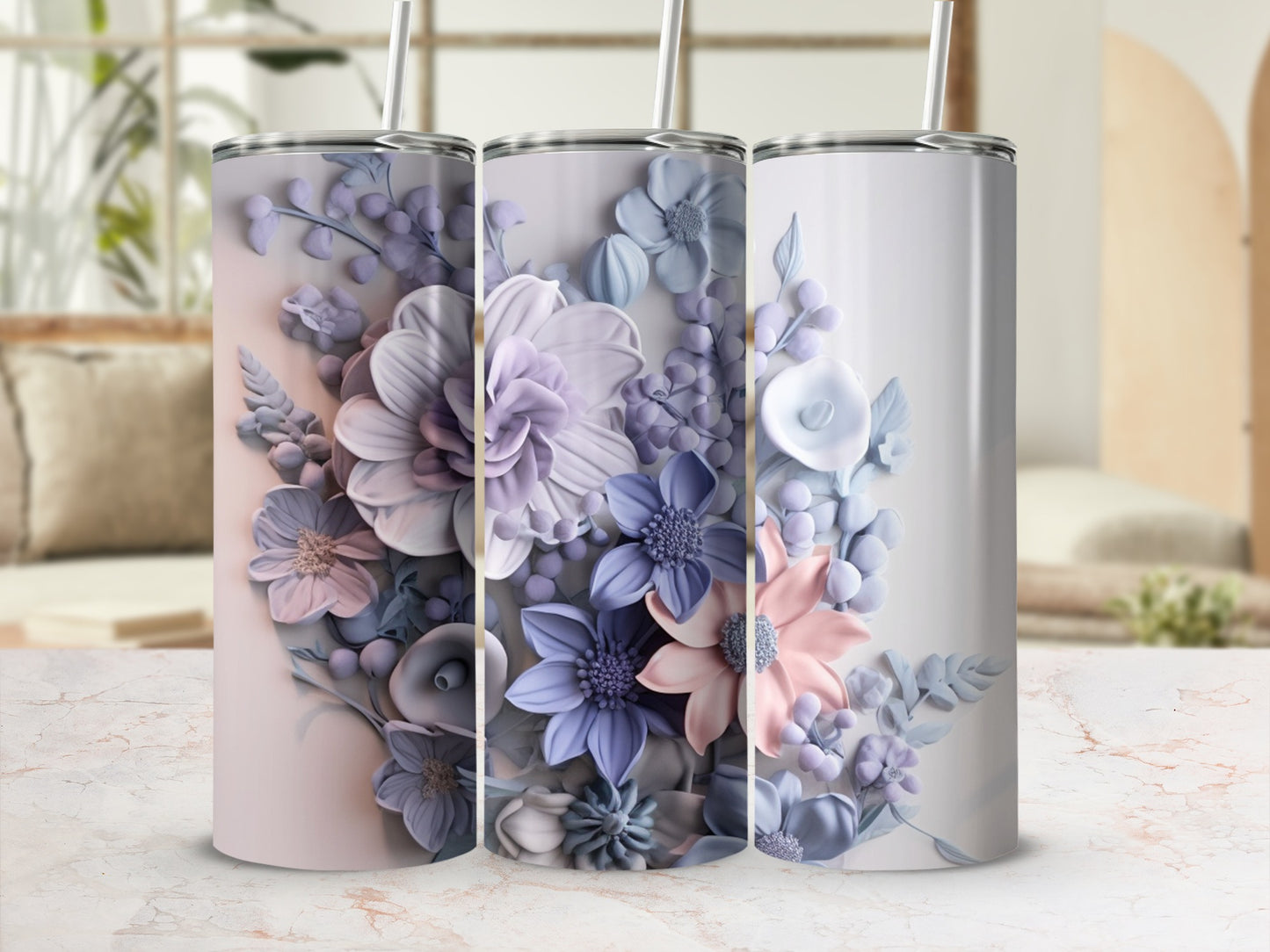 Three tall, slender tumblers adorned with delicate floral patterns in pastel shades.
