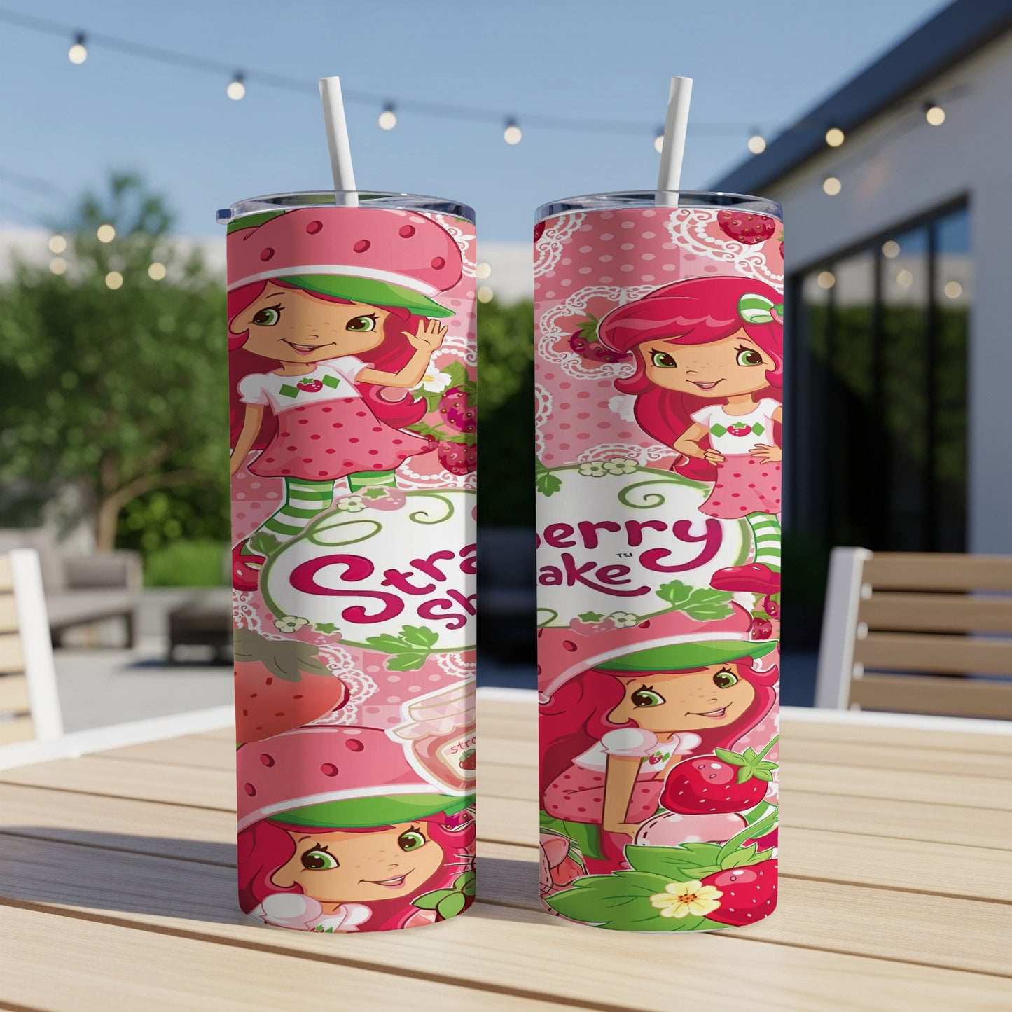 Strawberry Shortcake tumbler with pink and green floral pattern.