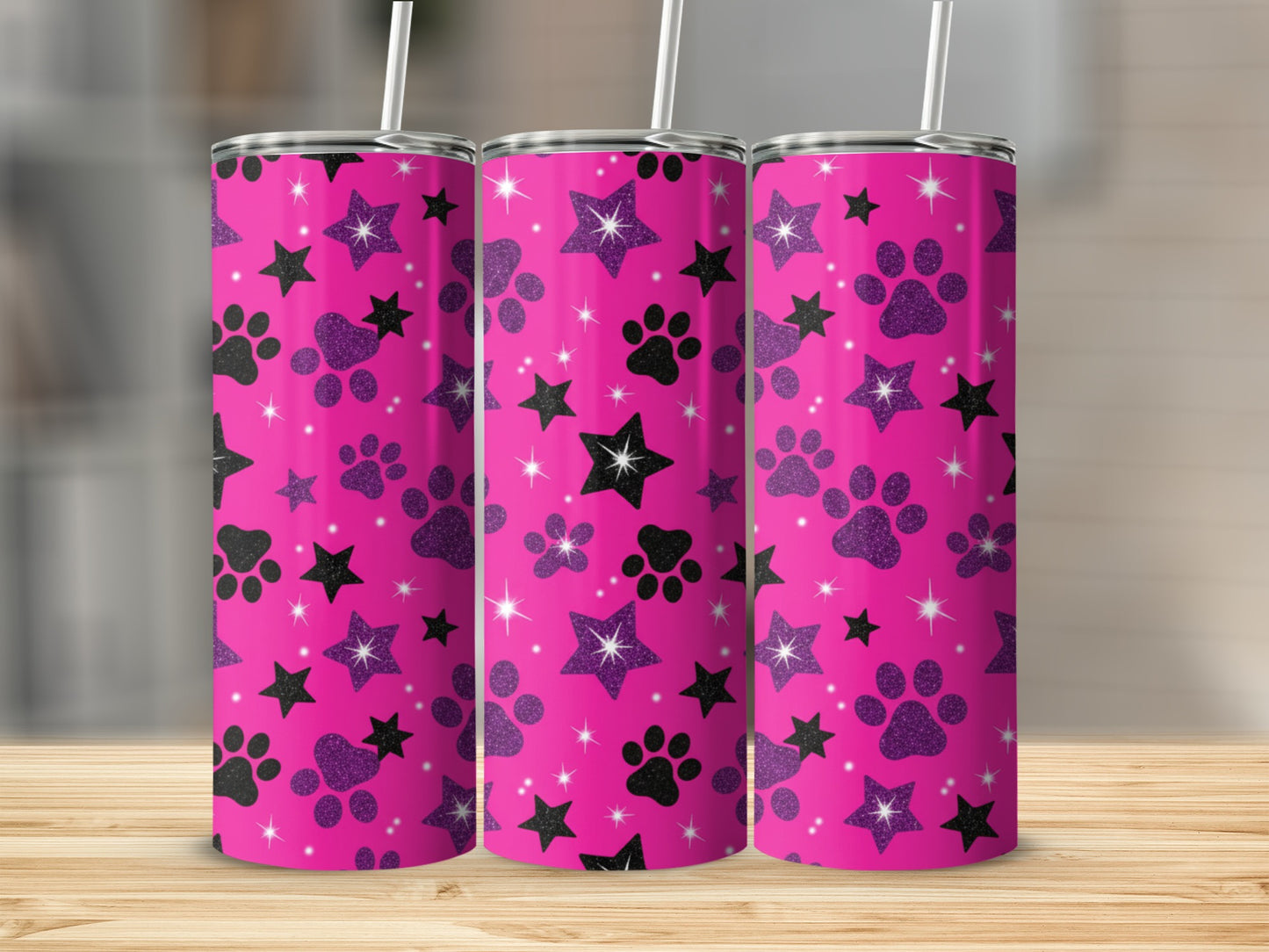 Pink tumbler with black paw prints and sparkly stars.