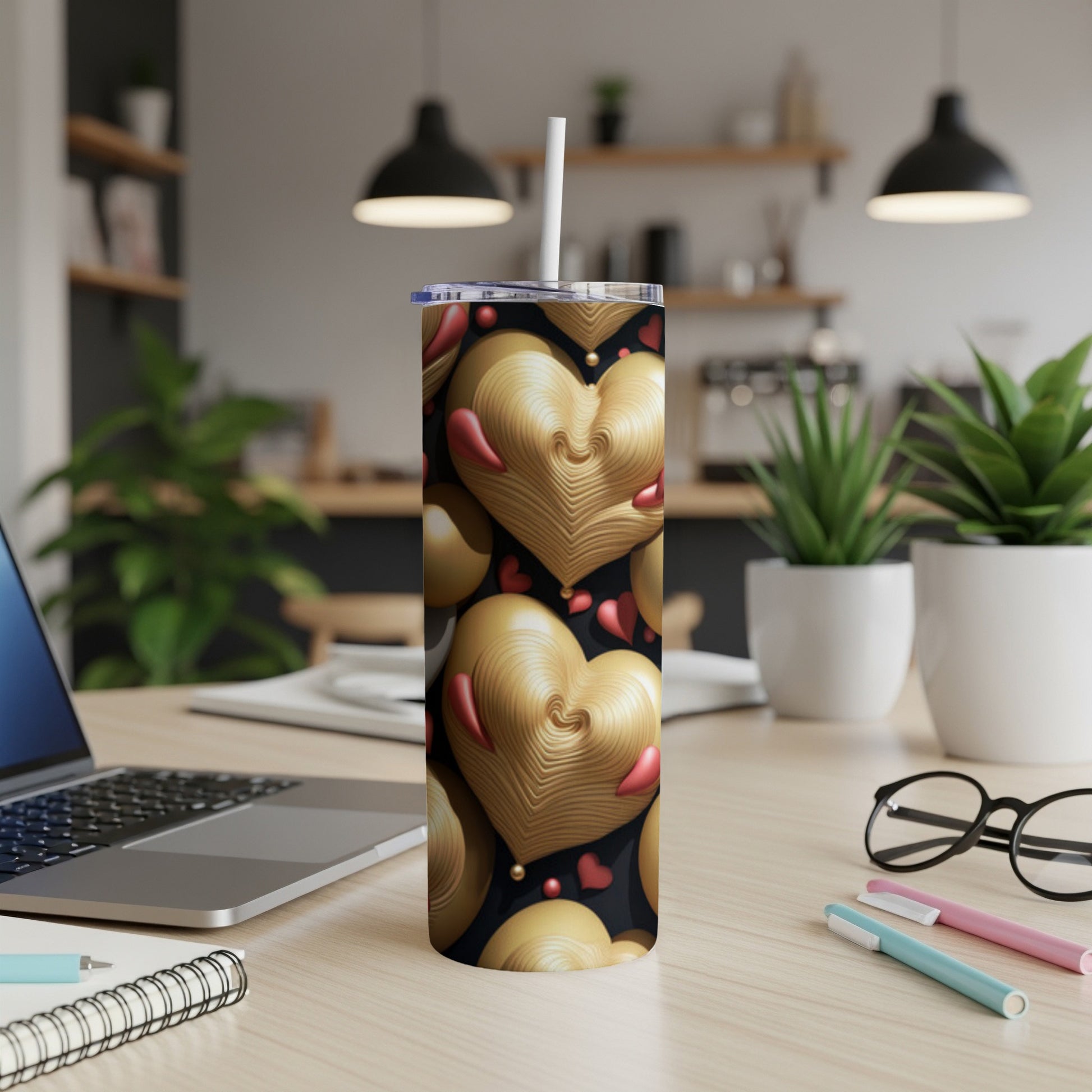Gold heart pattern on a black tumbler with a white straw.