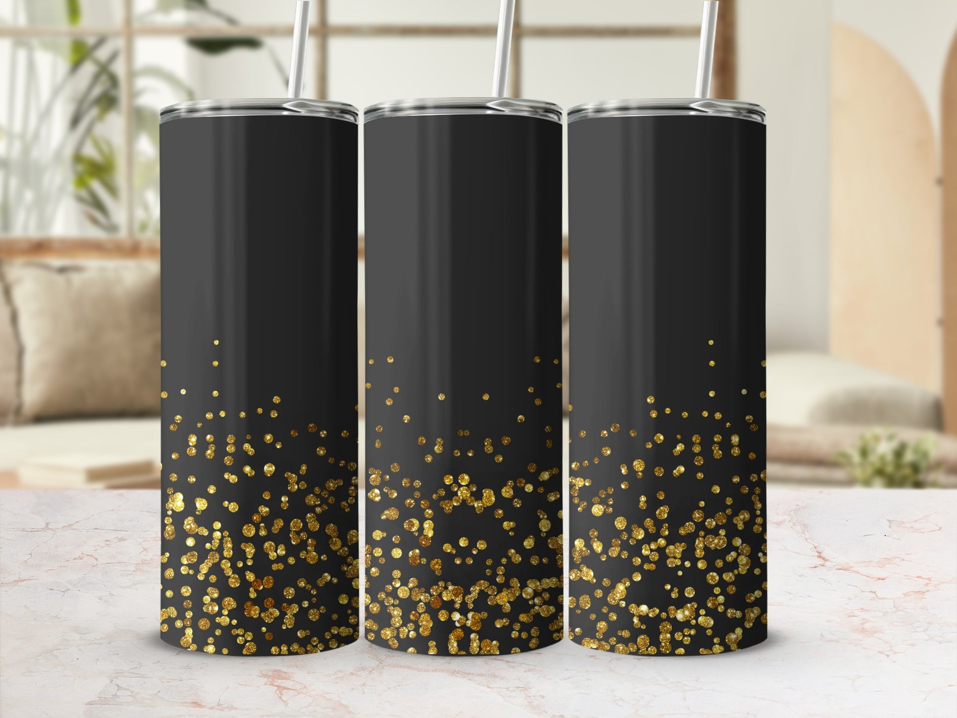 Three black tumblers with gold glitter gradient and straws.