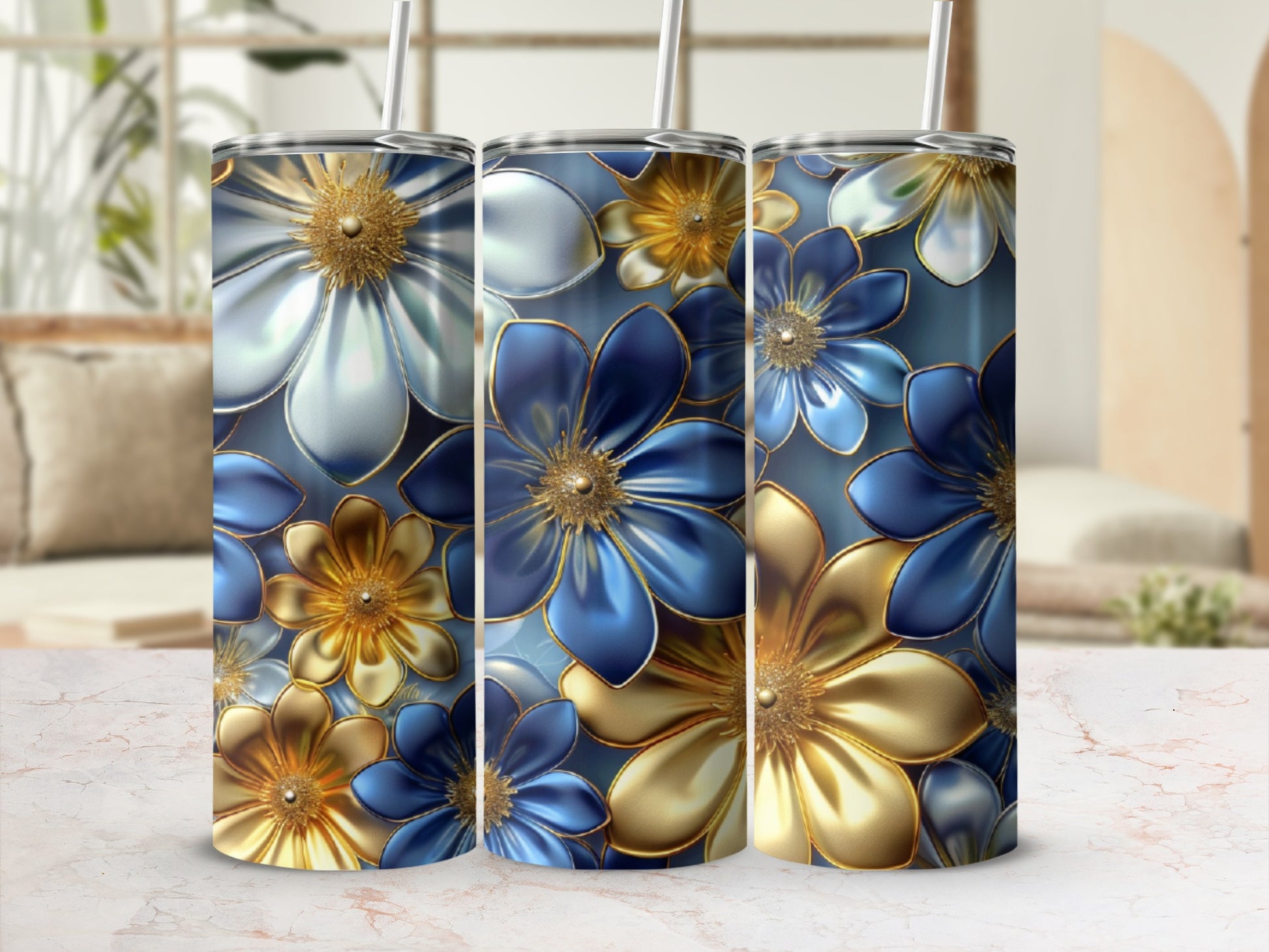 Three floral patterned tumblers with blue and gold flowers.
