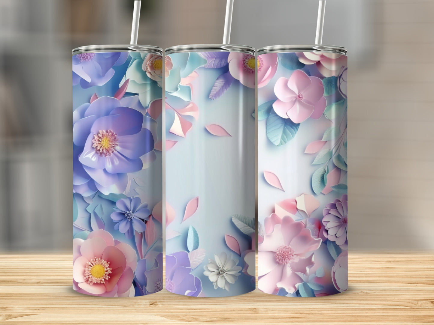 Three tumblers with pastel floral patterns on a wooden surface.