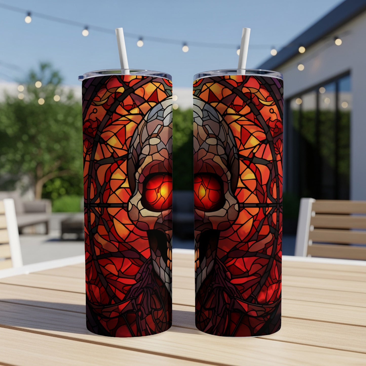 Two tumblers with a stained glass skull design, sitting on a table.