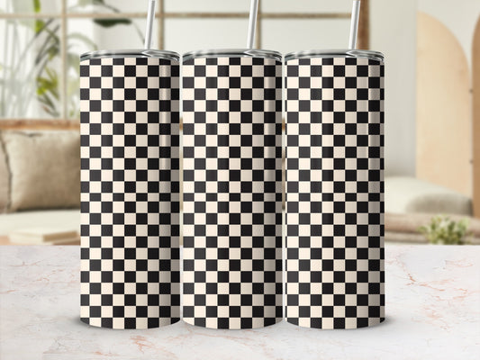 Three checkered tumblers with straws on a marble surface.