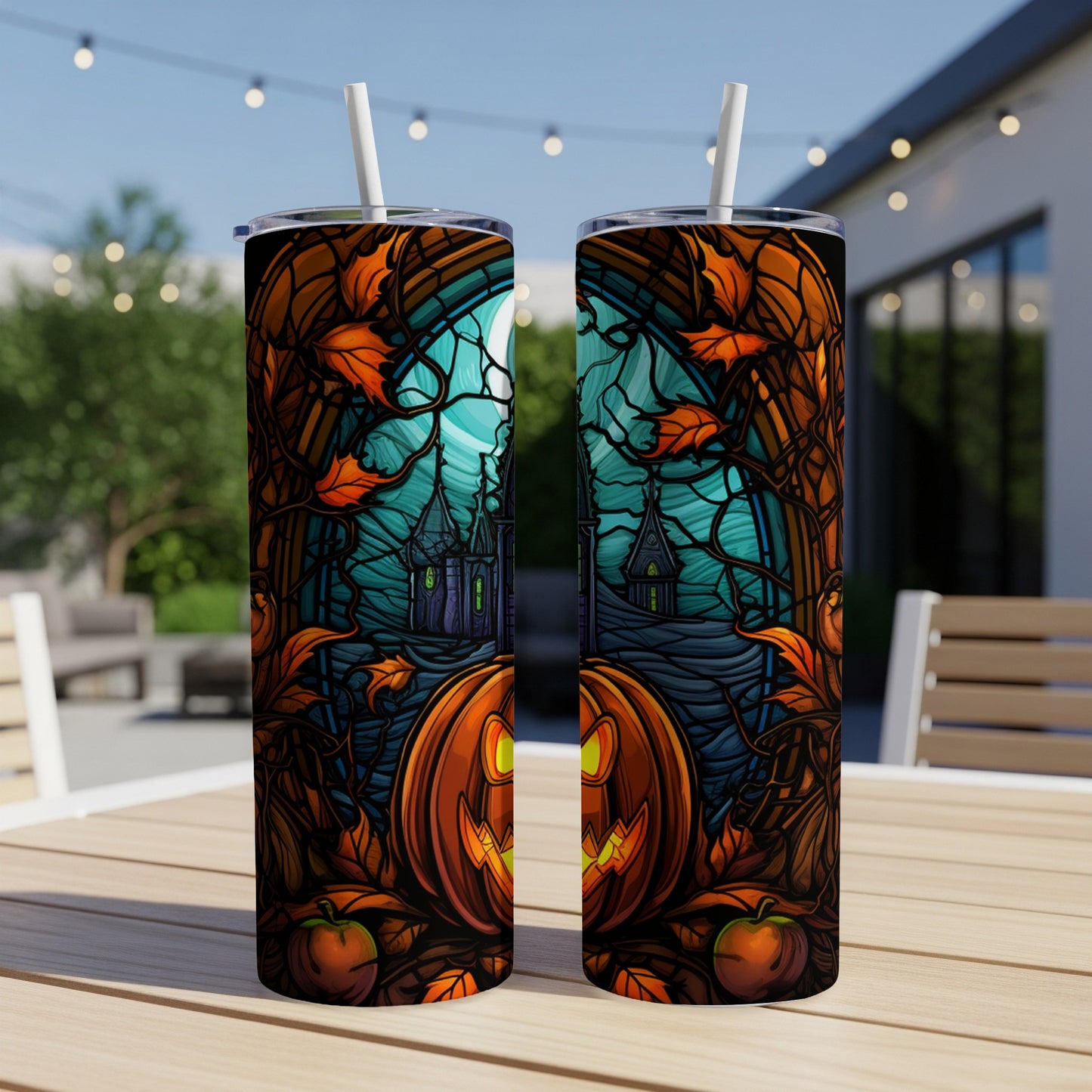 Halloween tumbler with pumpkin, haunted house, and autumn leaves design.
