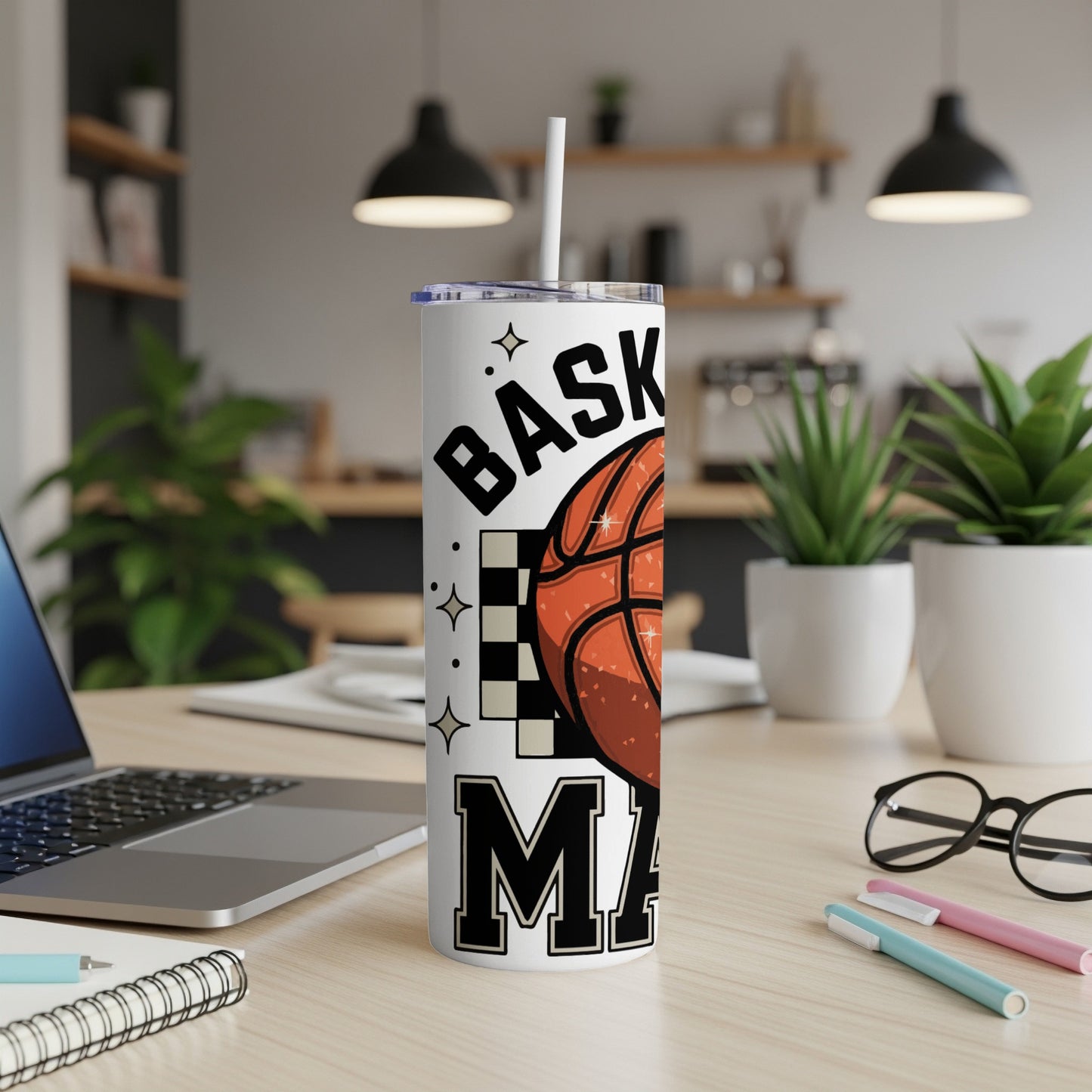 Basketball Mama tumbler with lid and straw, featuring text and checkerboard design.