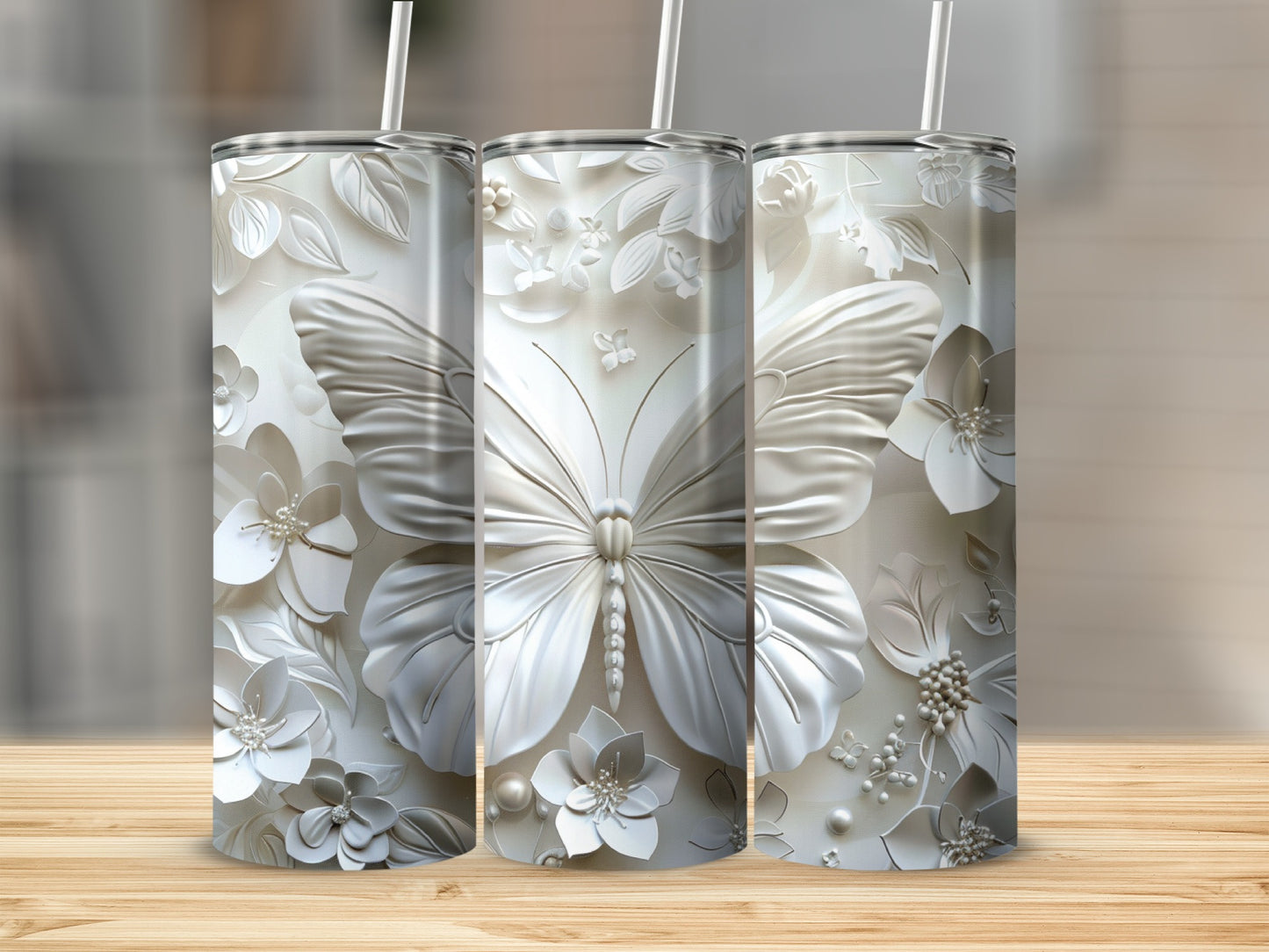 Three white tumblers with embossed butterflies and floral designs.