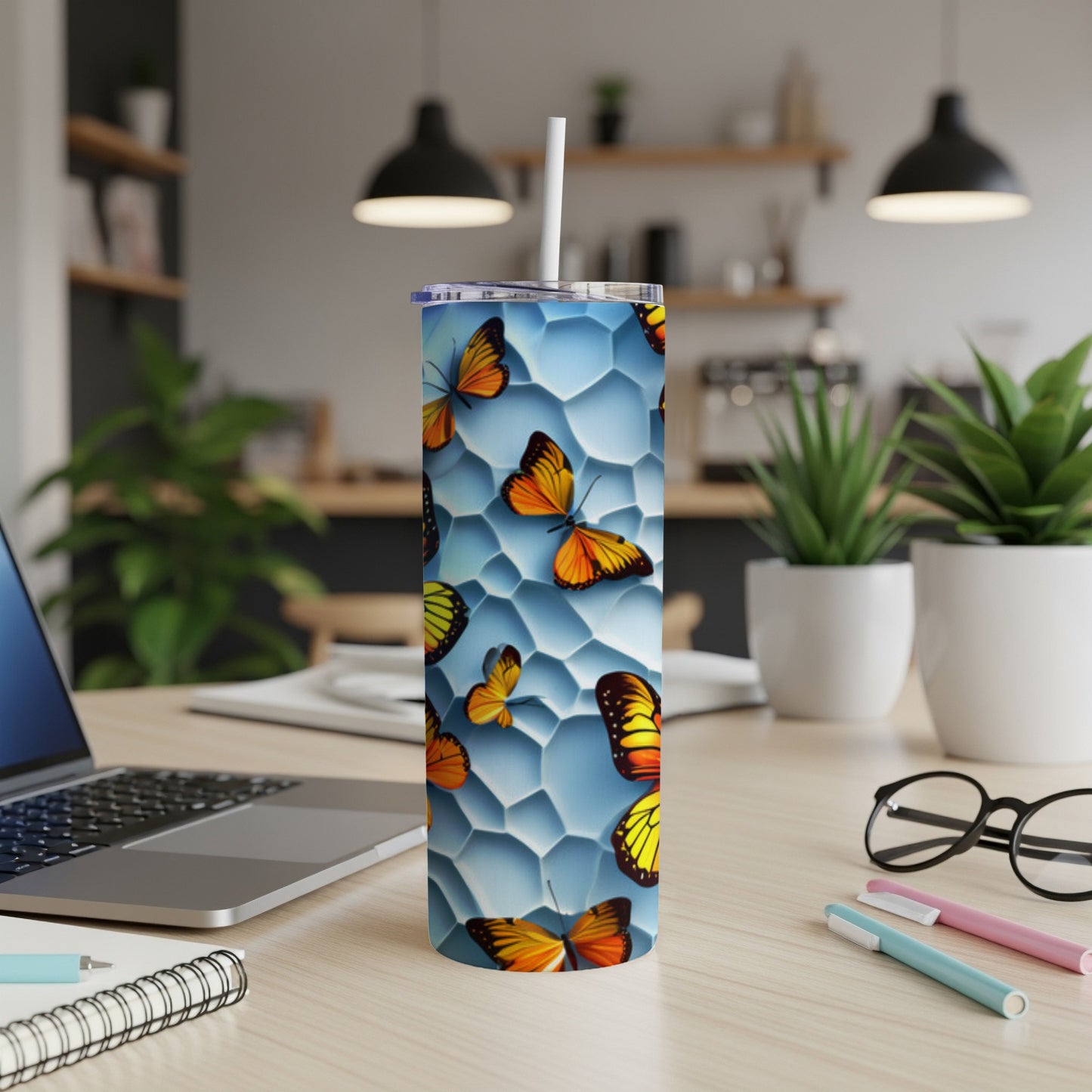 Tall tumbler with colorful butterflies on a hexagonal blue background.