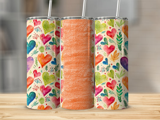 Three tumblers with a watercolor heart and leaf pattern, one with orange textured design.