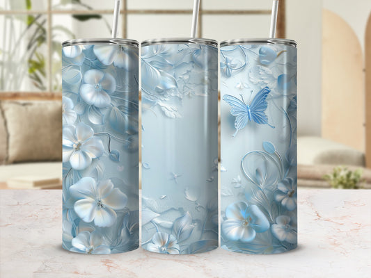 Light blue floral tumbler with butterfly, white flowers, and textured background.