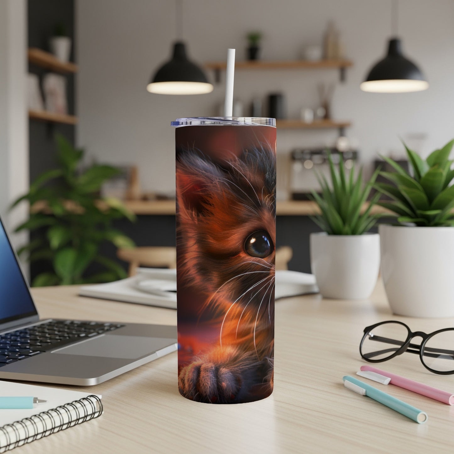 Close-up of a fluffy cat's face on a tumbler with a straw.
