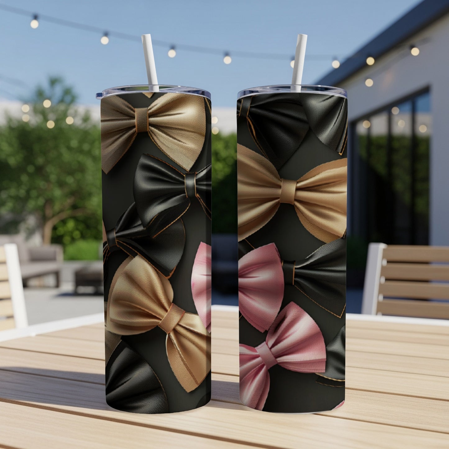 Two tumblers with black and gold bow patterns on a table.