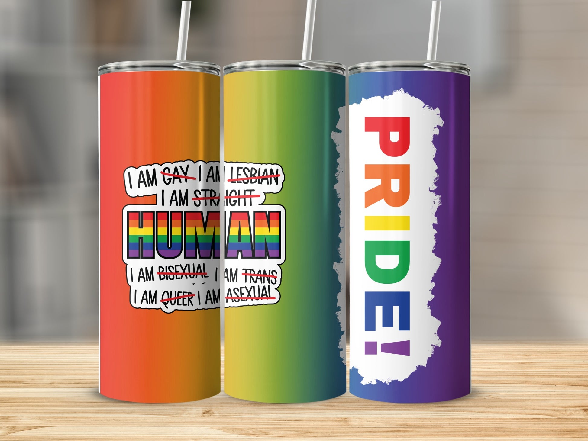 Three tumblers featuring "PRIDE!" text and "I AM HUMAN" with various LGBTQ+ identities listed.