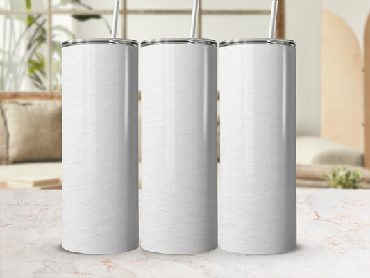 Three blank white tumblers with straws on a marble countertop.