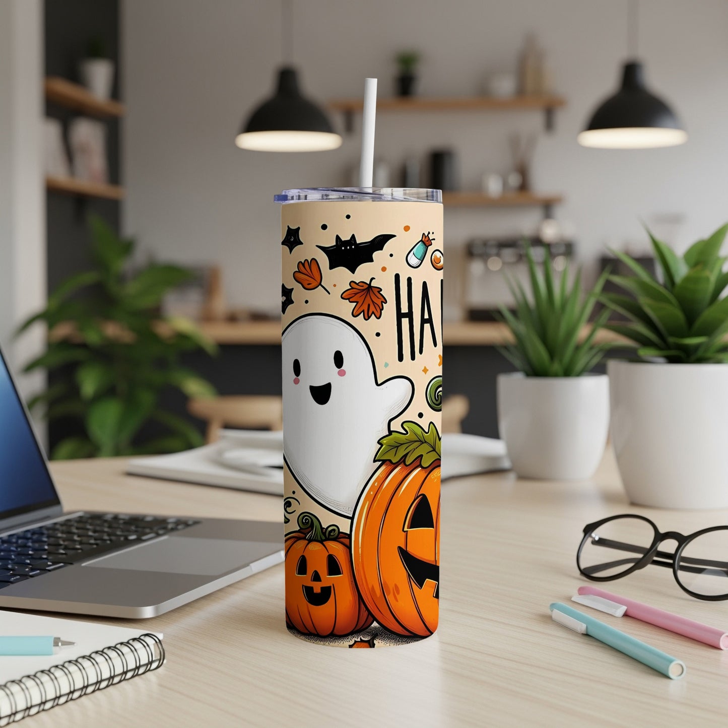 Halloween tumbler with ghost, pumpkins, bats, and "HA" text.