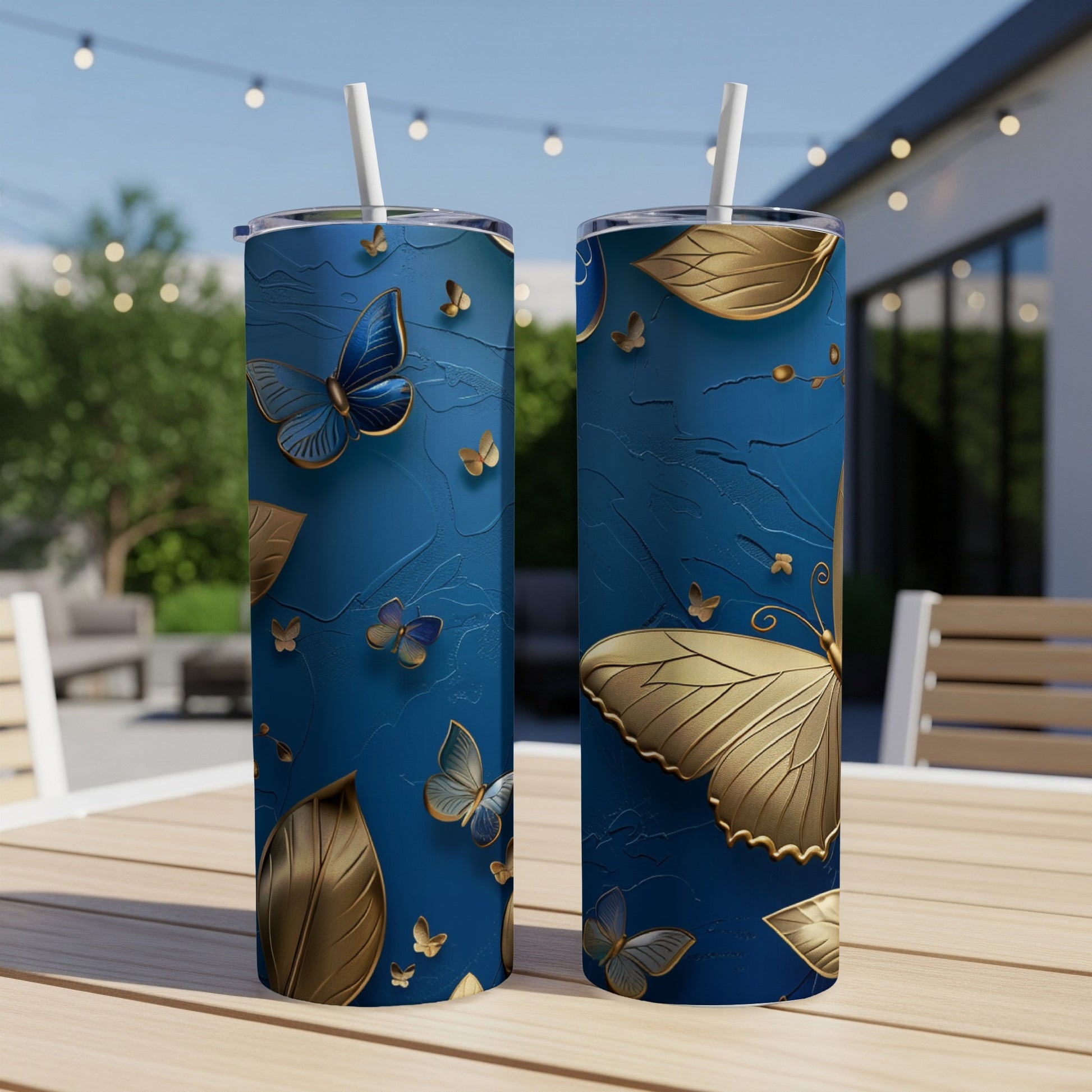 Two blue tumblers with gold butterflies and leaves design.