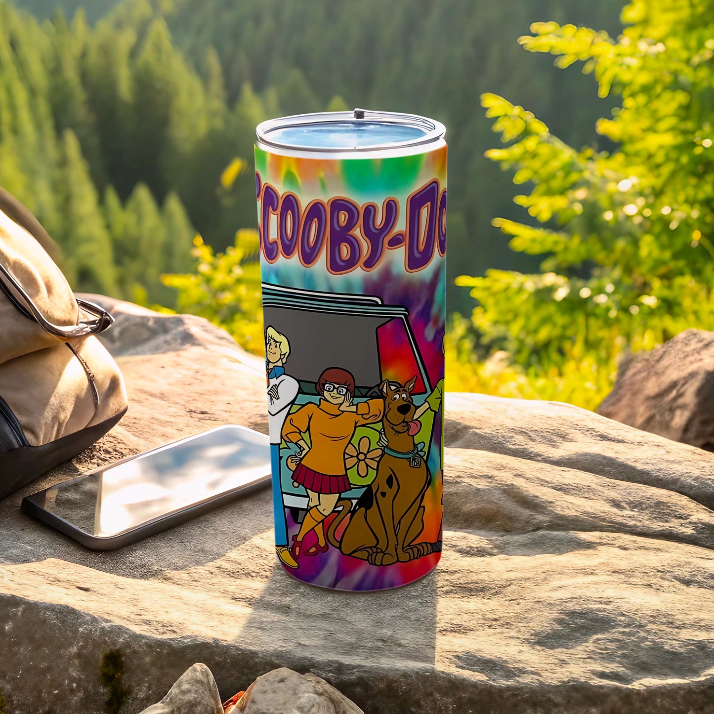 Scooby-Doo characters on a tie-dye tumbler with a mountain background.