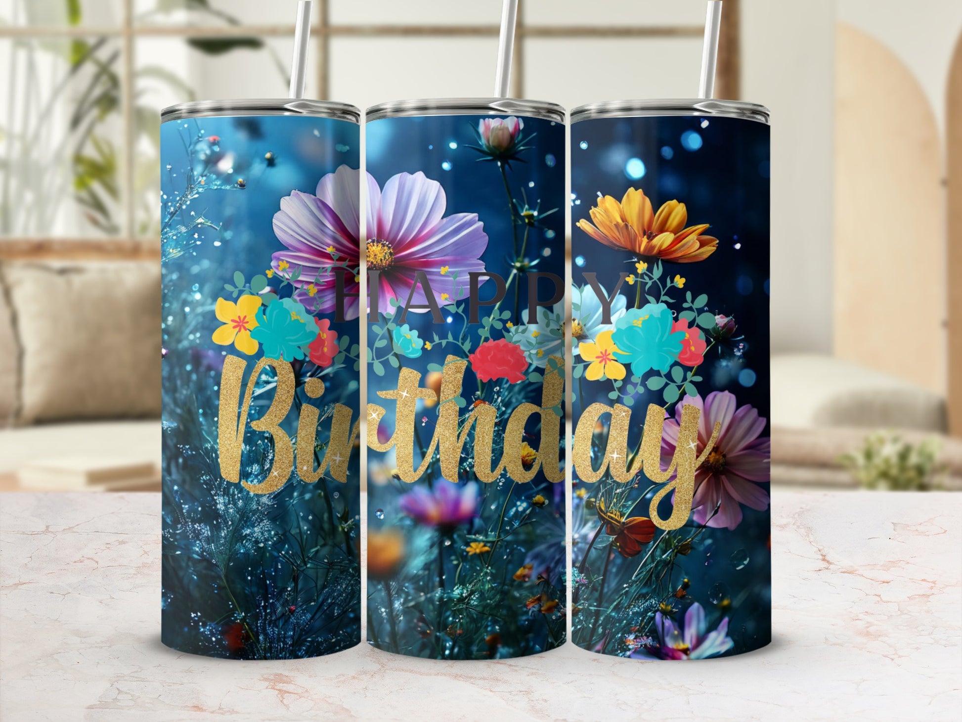 Floral birthday tumbler with golden cursive text on a blurred background.