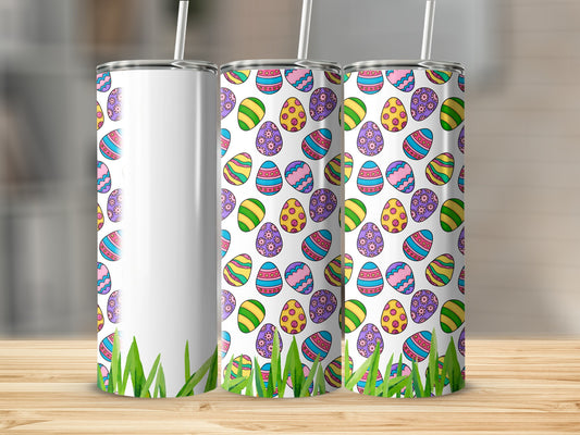 Three Easter-themed tumblers with colorful egg patterns and green grass accents.