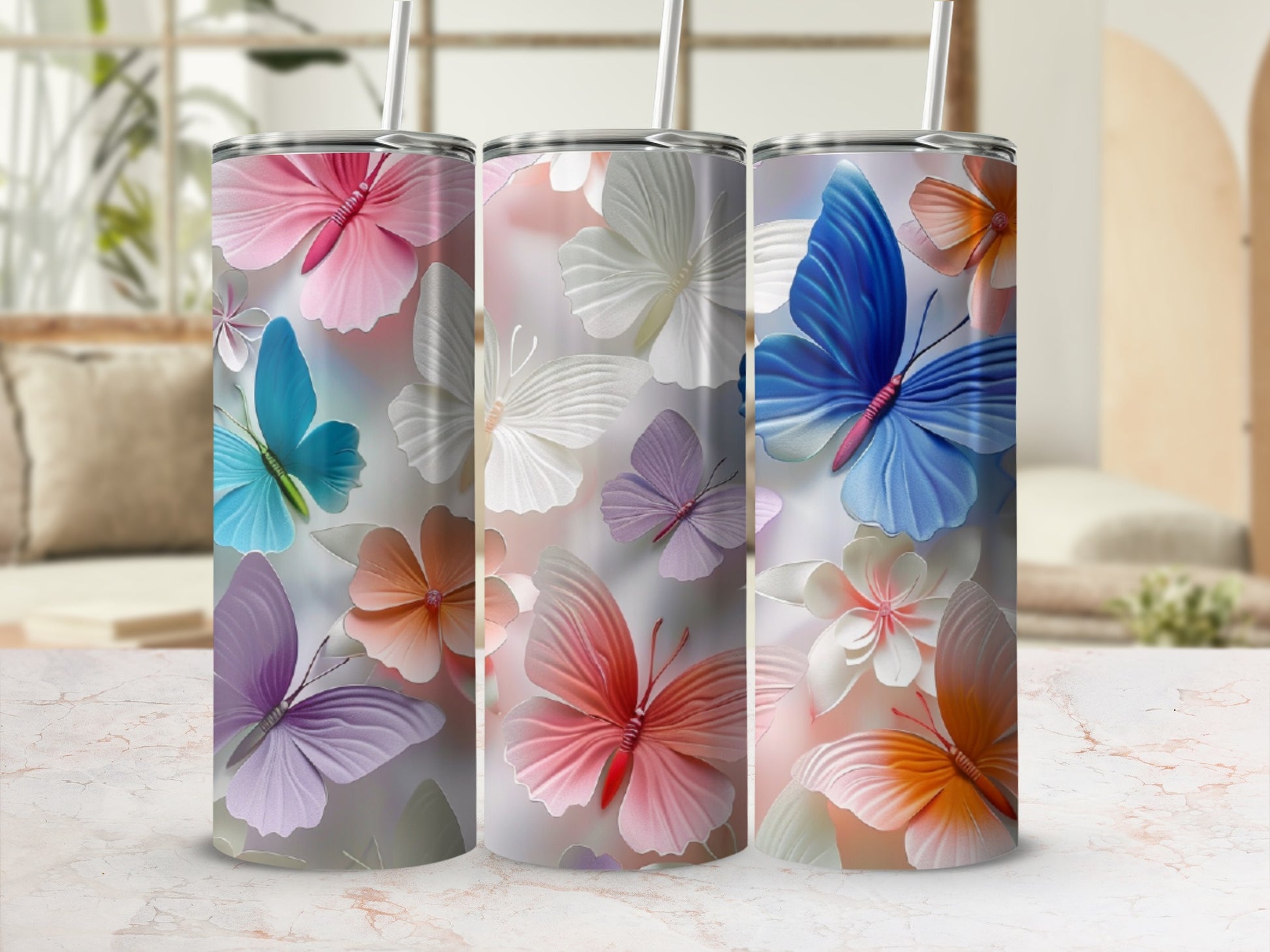 Three tumblers with floral butterfly patterns in soft pastel colors.