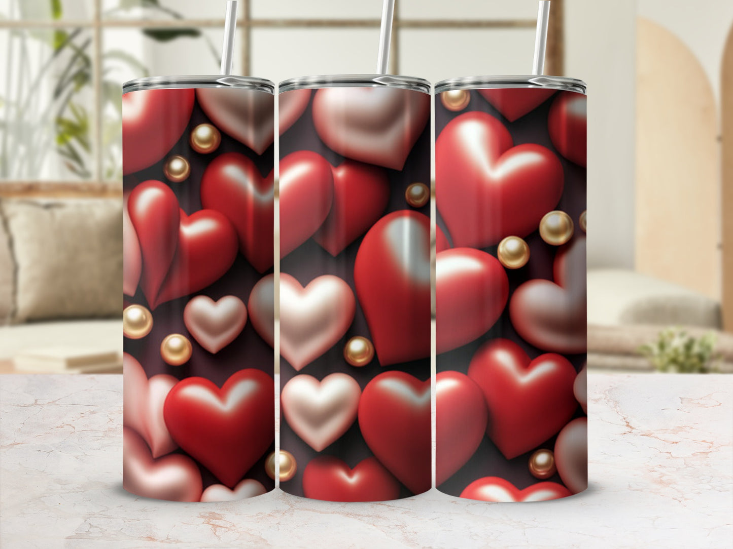Three tumblers with a pattern of red and pink hearts and gold beads.