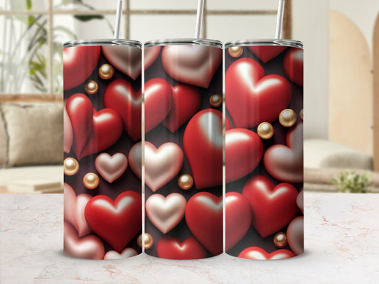 Three tumblers with a pattern of red and pink hearts and gold beads.