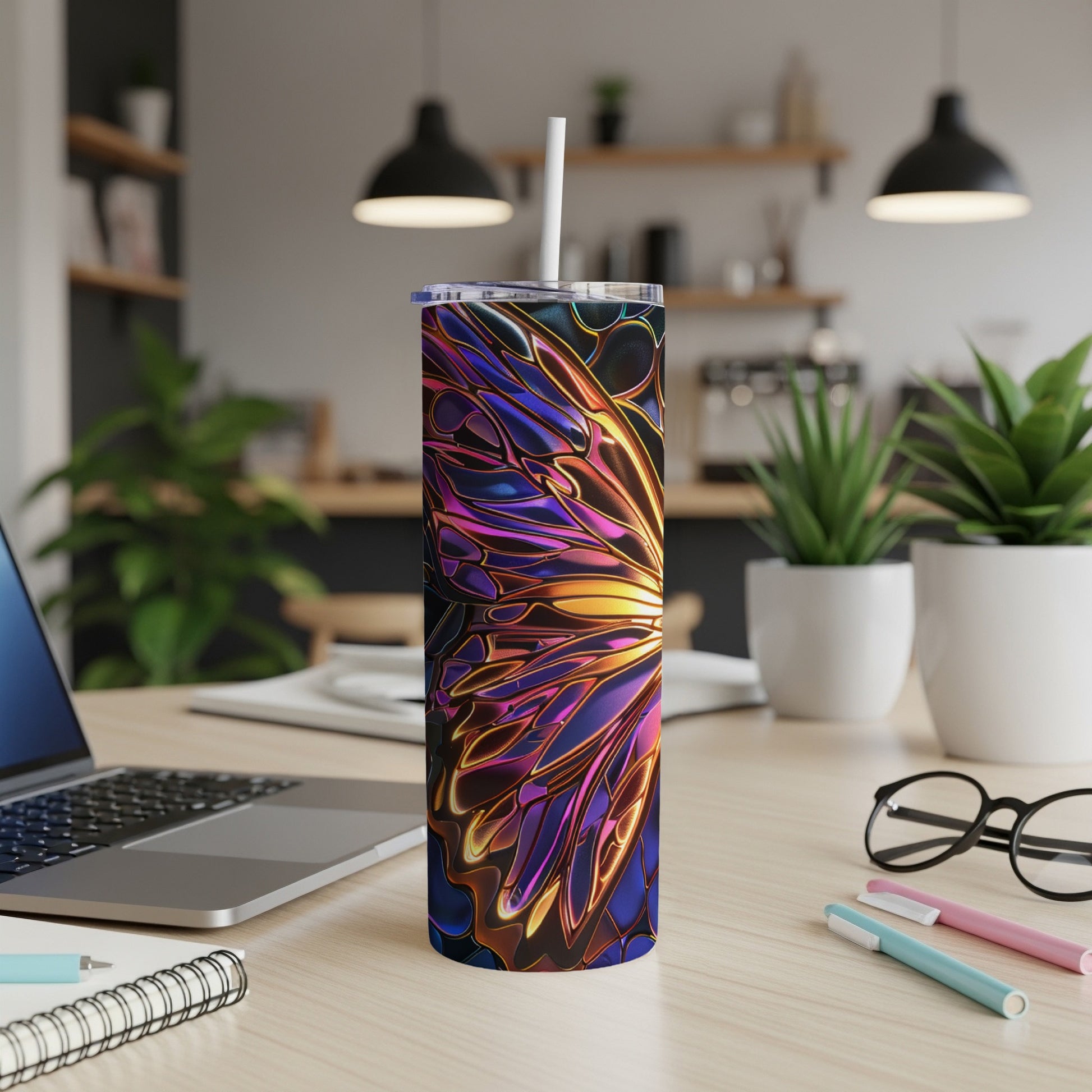 Tumbler with iridescent butterfly wing design on a desk.
