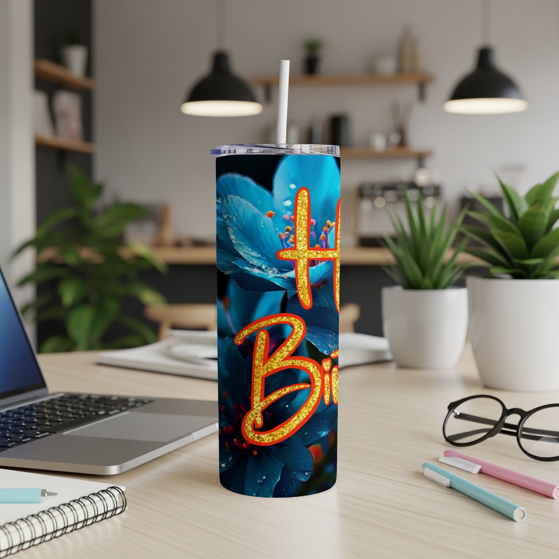 Tumbler with "Happy Birthday" text overlaying blue flowers.