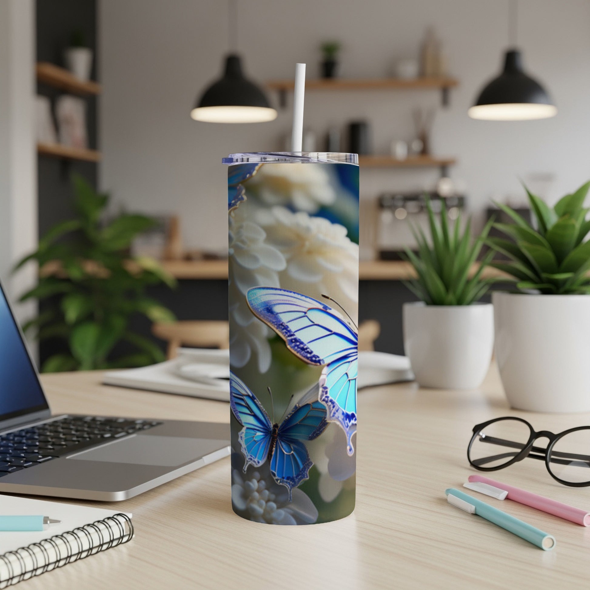 Blue butterflies on a floral pattern tumbler with a straw.