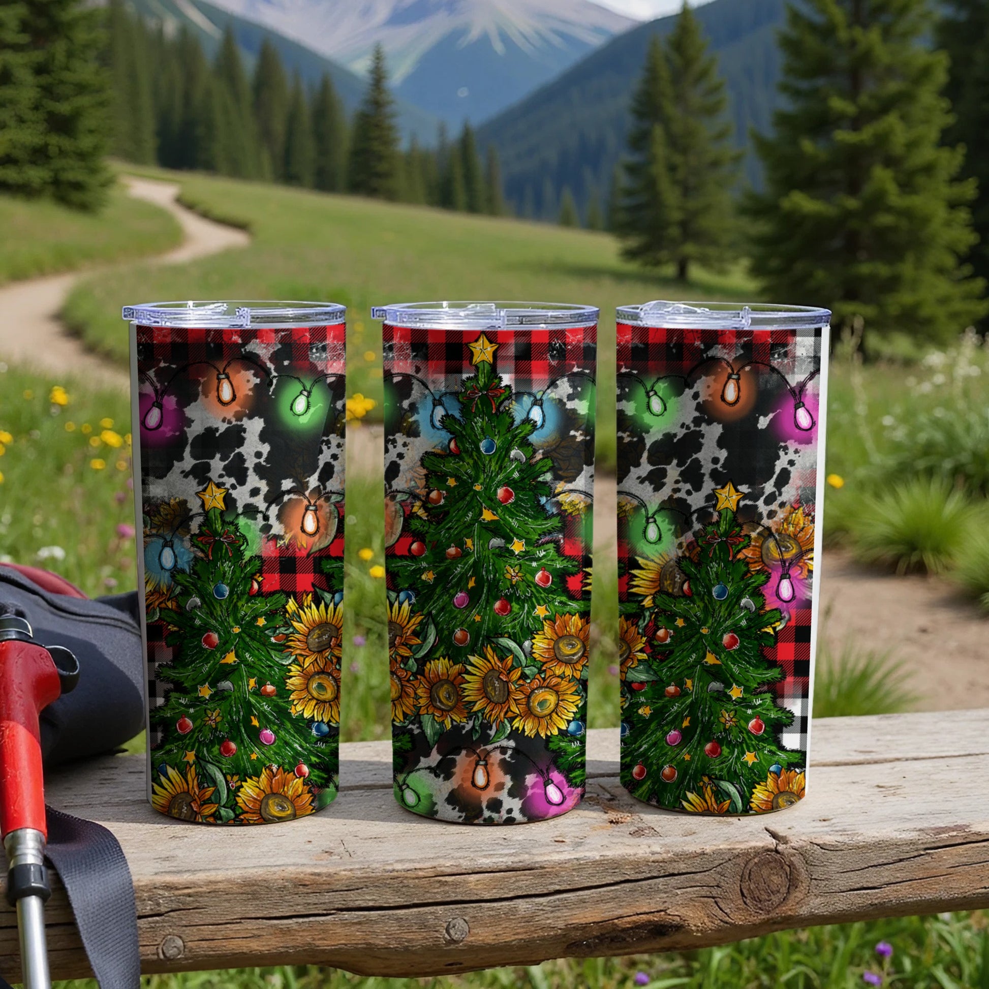 Three tumblers with Christmas tree, sunflowers, and cow print designs.