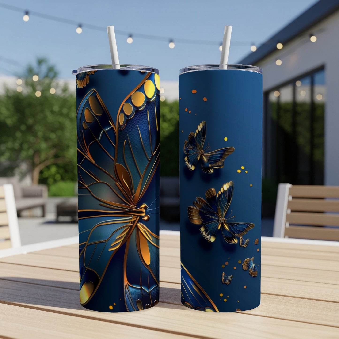 Two tall, dark blue tumblers with gold and blue butterfly designs.