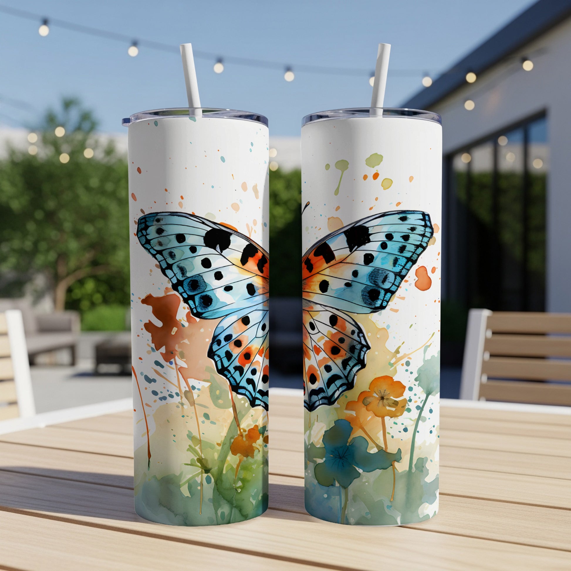 Two skinny tumblers featuring a watercolor butterfly and floral design.