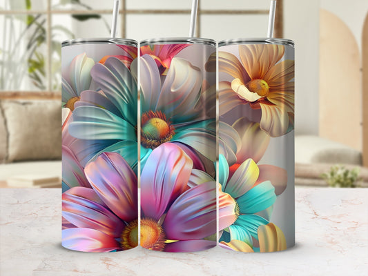 Three tumblers with colorful floral designs and straw lids.