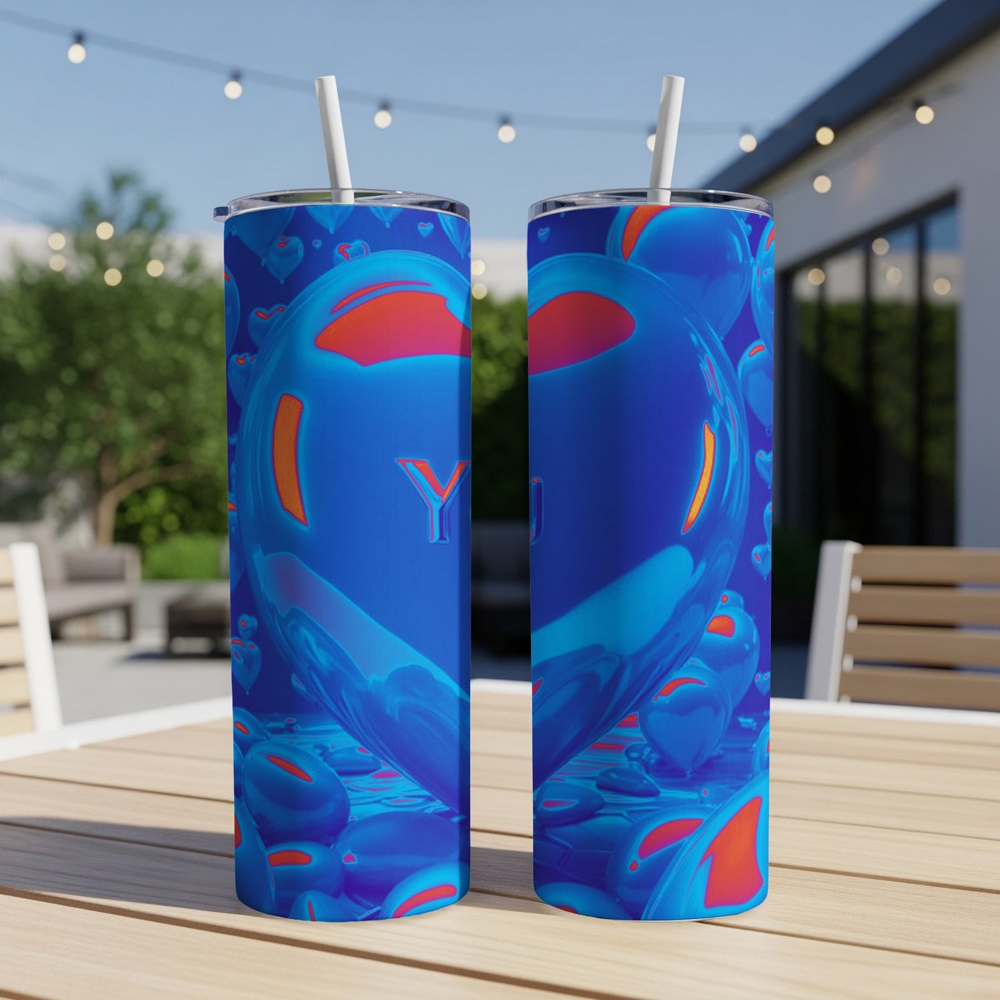 Two blue tumblers with a Y on them and heart designs.