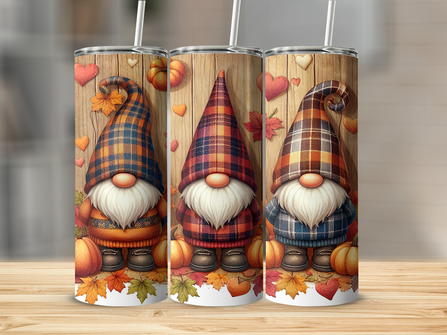 Three gnomes in plaid outfits with pumpkins and leaves on a wooden background.
