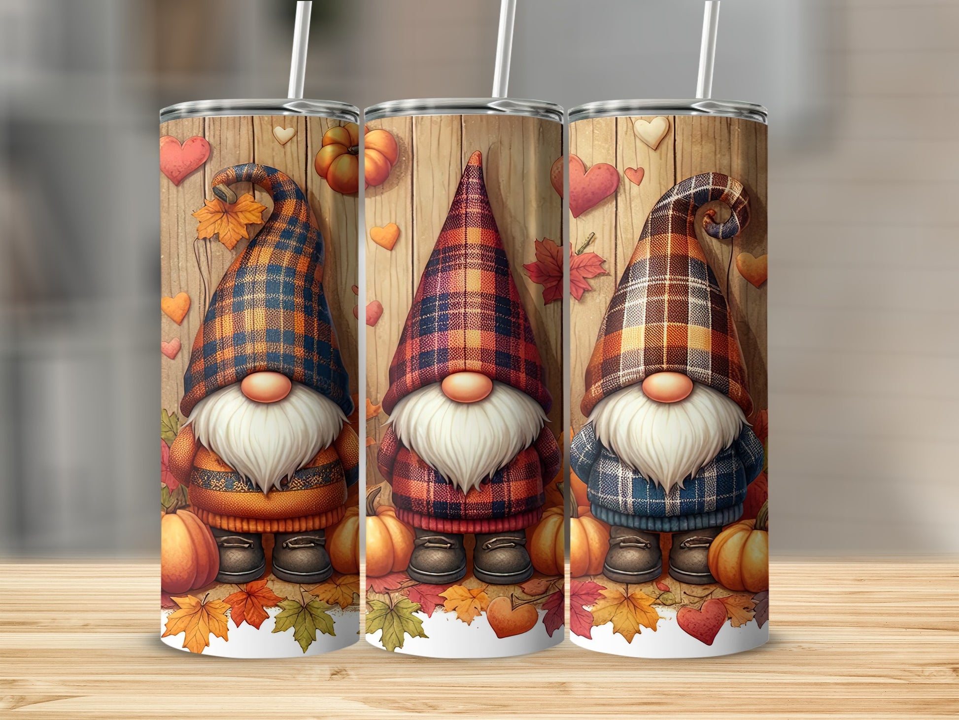 Three gnomes in plaid outfits with pumpkins and leaves on a wooden background.