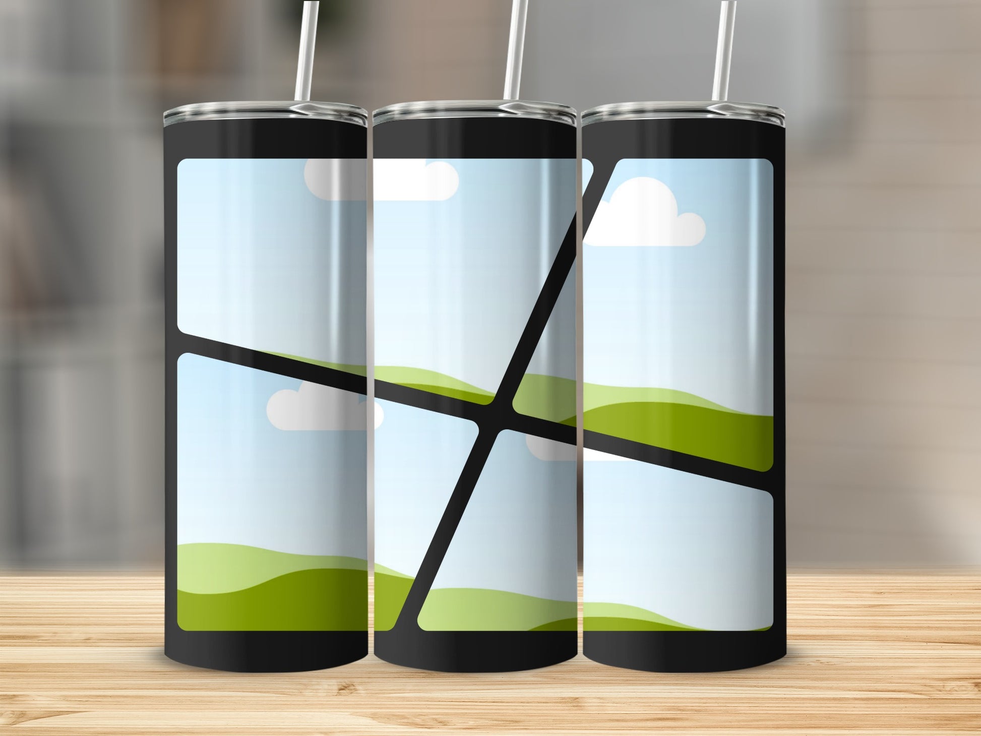 Three black tumblers with a landscape design of hills and clouds.