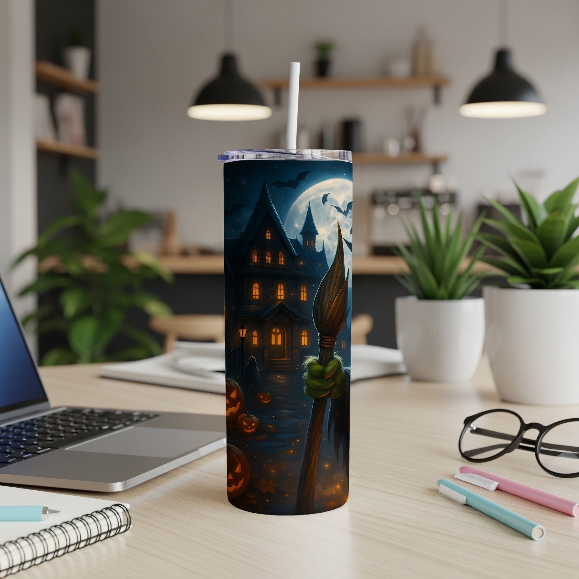 Halloween tumbler with haunted house, bats, pumpkins, and a witch's hand holding a broom.