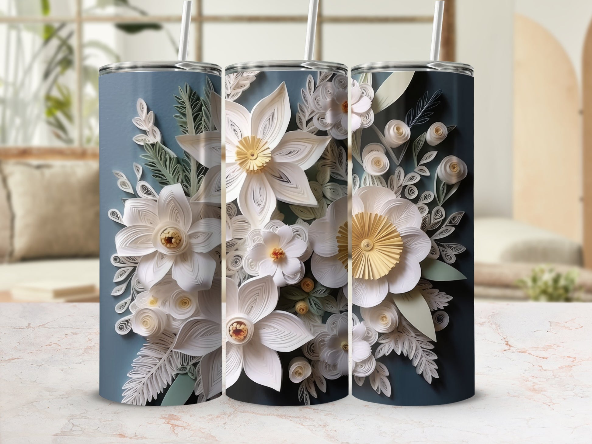 Three tall tumblers with white floral designs on a blue background.