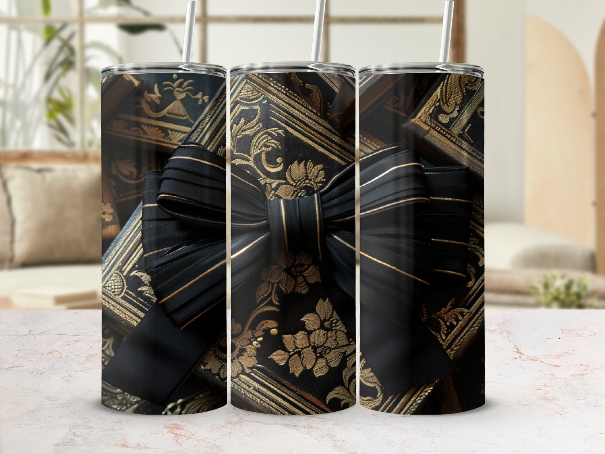 Three tumblers with ornate gold and black floral pattern and black bow.