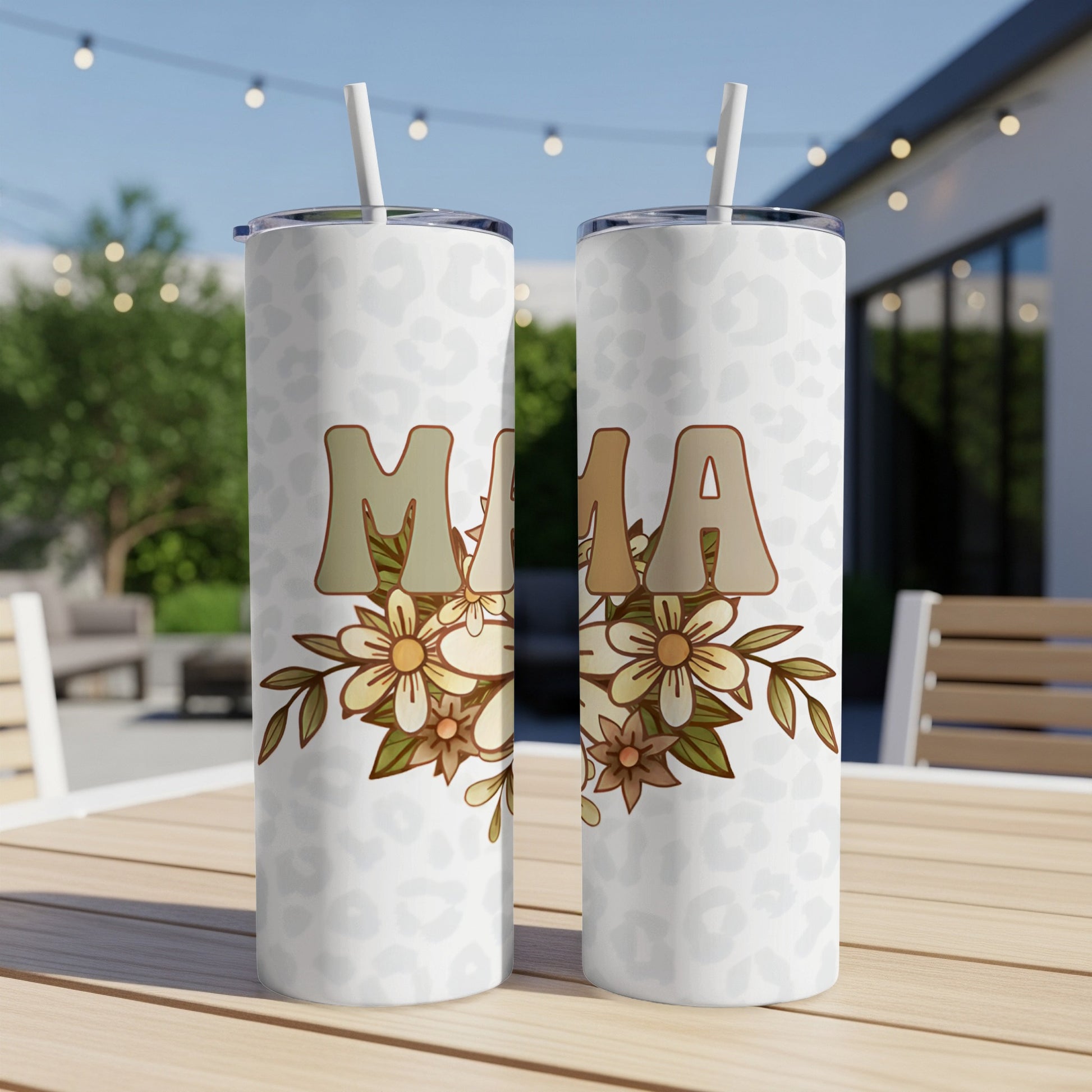 Two tumblers with "MAMA" text and floral design on a table.
