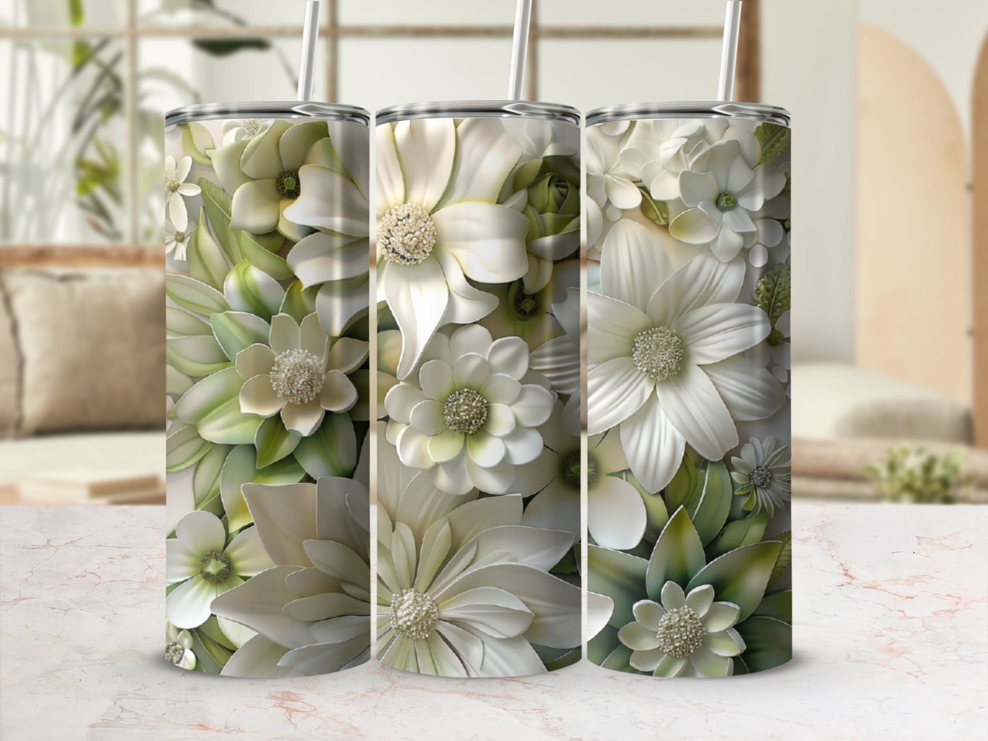 Floral pattern tumblers with straws on marbled surface.