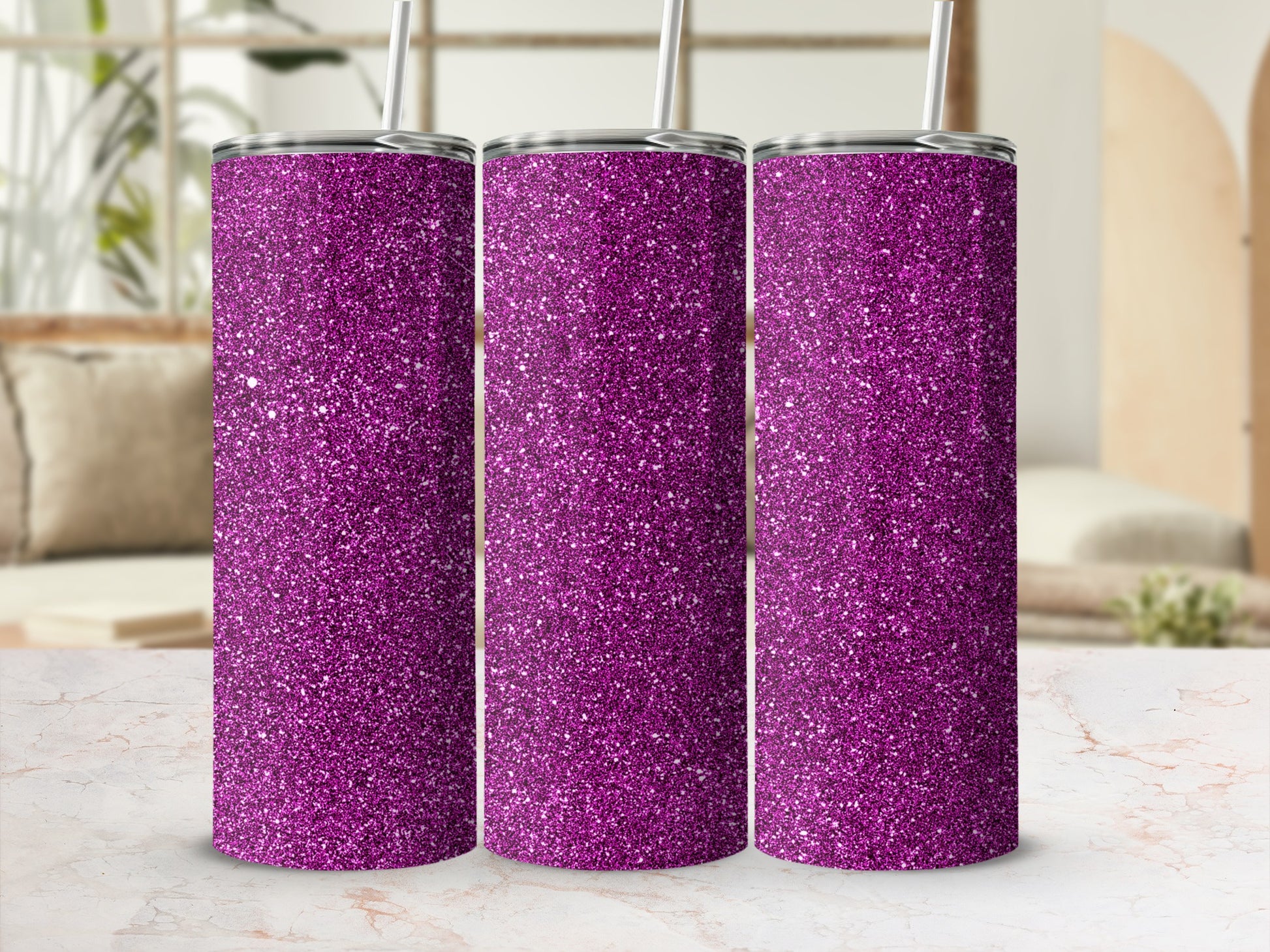Three purple glitter tumblers with white straws stand on a marble surface.